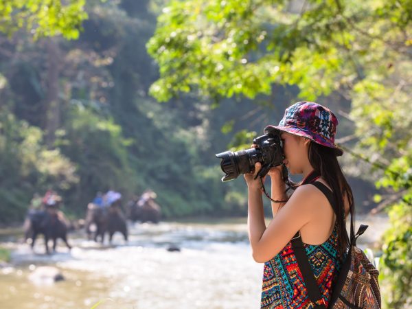 Female tourists who are taking photos of the atmosphere and smile happily.