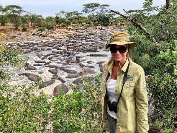 young-man-wearing-sunglasses-standing-by-plants